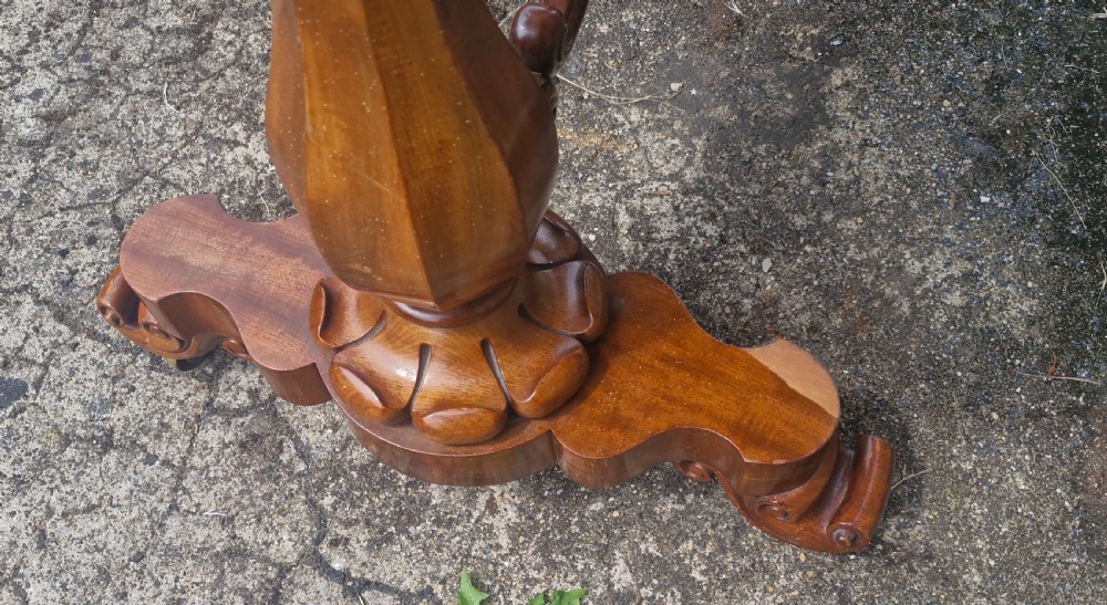 A mid-19th-century mahogany kidney-shaped side table featuring turned pedestal supports, a carved scrolled stretcher, and shaped feet. View IX