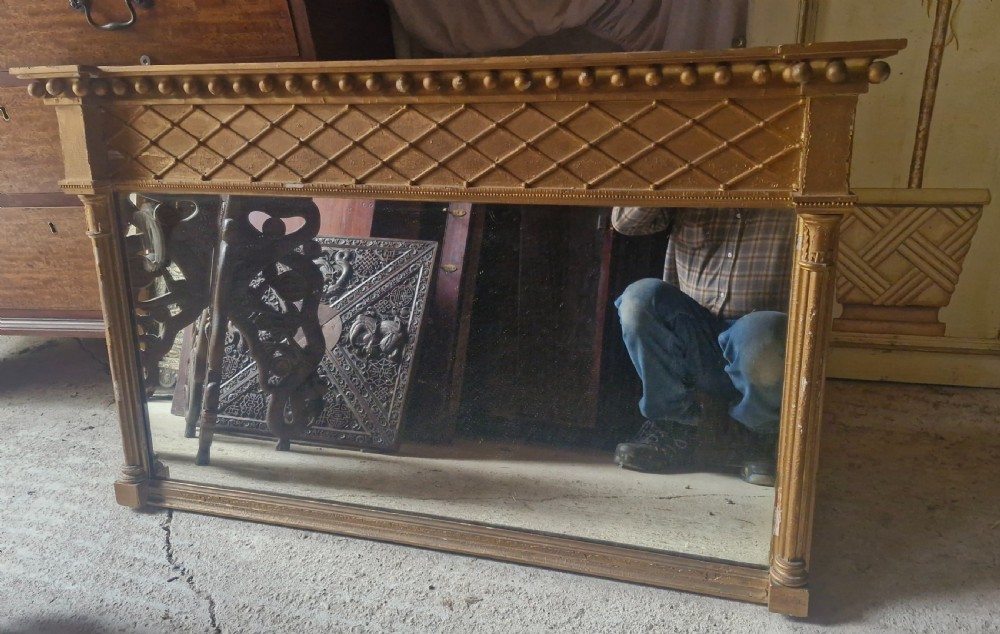 A 19th-century rectangular giltwood overmantel mirror featuring a lattice frieze, ball moulding along the top cornice, and flanking fluted columns. View IV