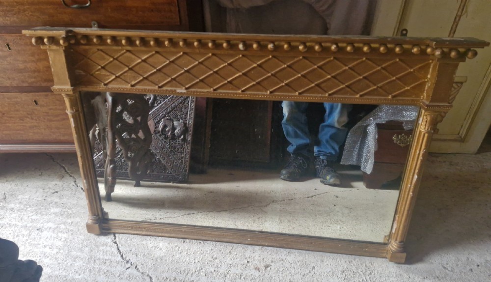 A 19th-century rectangular giltwood overmantel mirror featuring a lattice frieze, ball moulding along the top cornice, and flanking fluted columns. View V