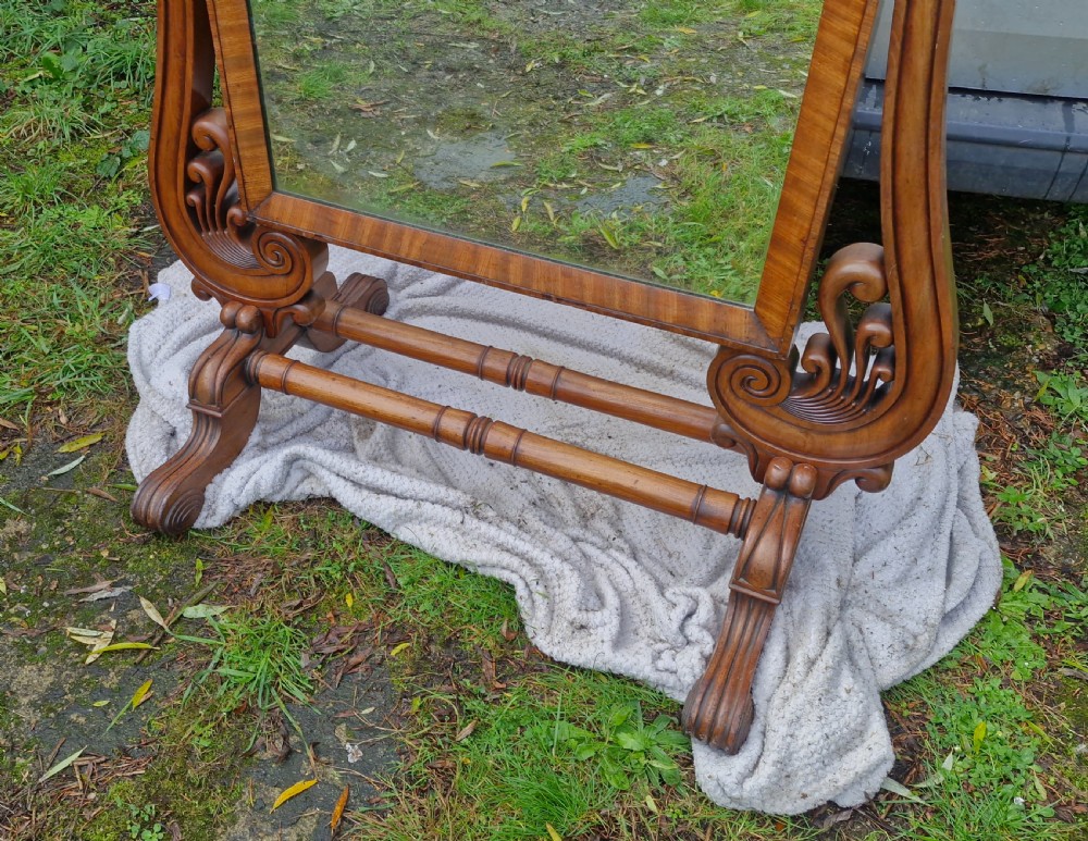 A large Regency mahogany cheval dressing mirror featuring a tilting rectangular frame set between carved scroll uprights and turned stretchers. View VI