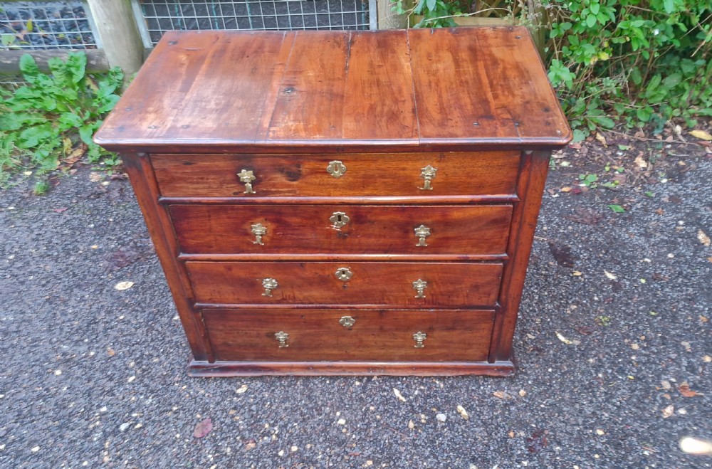 A William and Mary walnut chest featuring four graduated drawers with brass drop handles and escutcheons. View II