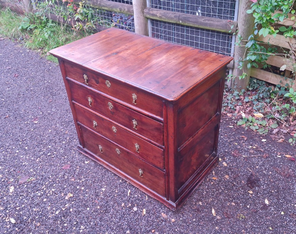 A William and Mary walnut chest featuring four graduated drawers with brass drop handles and escutcheons. View VIII