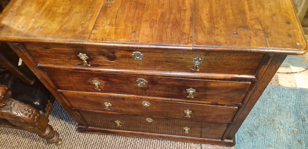 A William and Mary walnut chest featuring four graduated drawers with brass drop handles and escutcheons. View XI