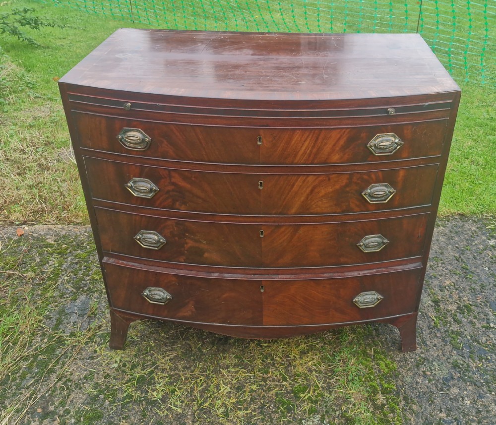 Regency mahogany bow front chest with brushing slide. 