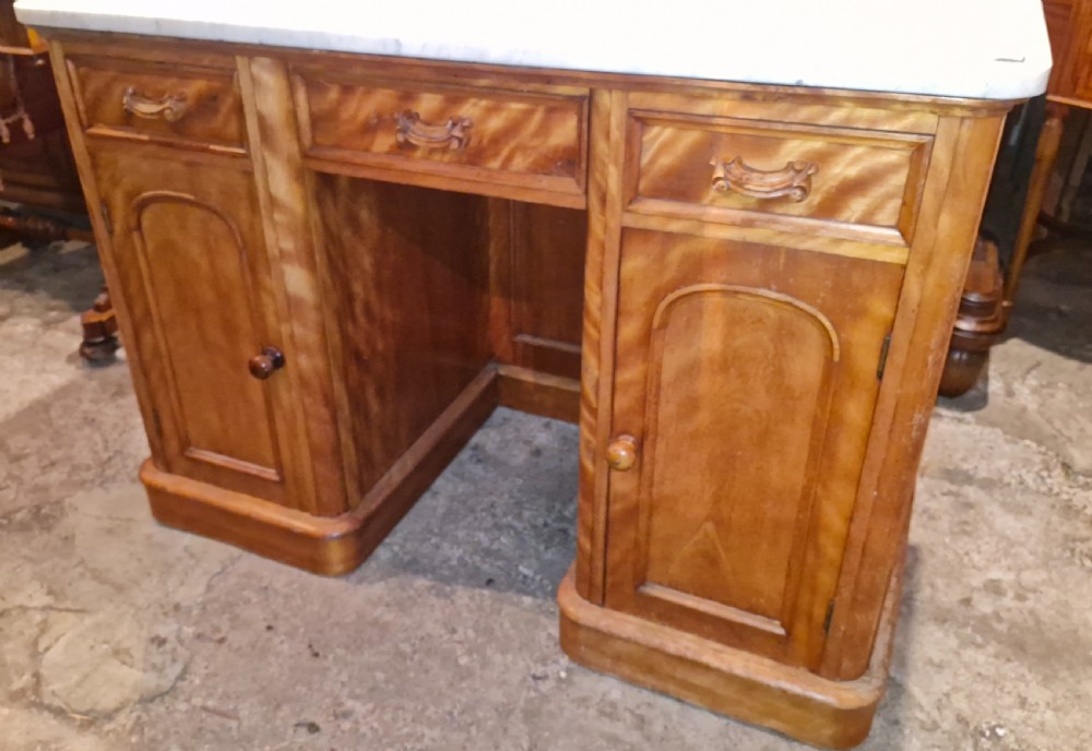A Victorian satinbirch pedestal washstand featuring a fitted white marble surface with a raised splashback gallery and twin cupboard pedestals. View VIII