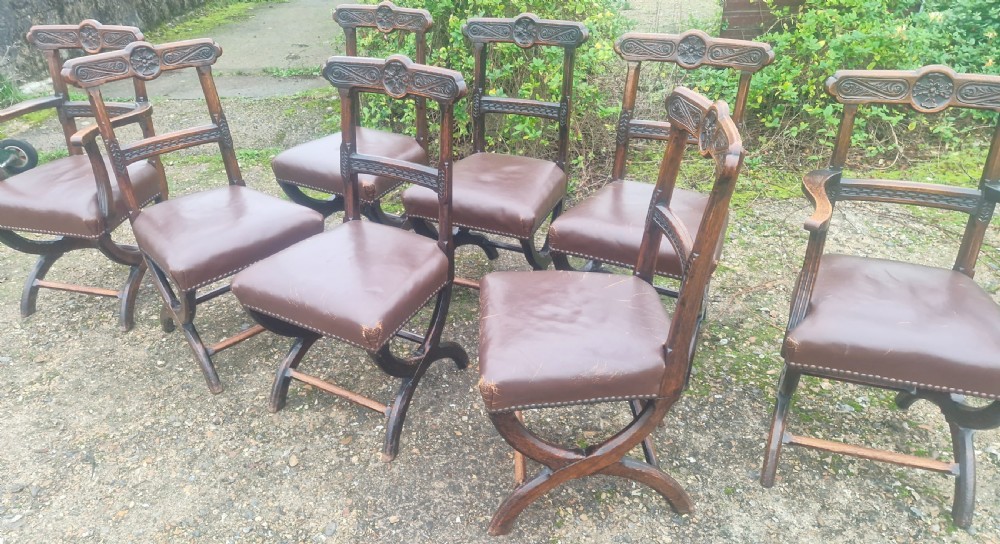 Set of 8 Victorian carved oak Gothic X frame dining chairs . View VI