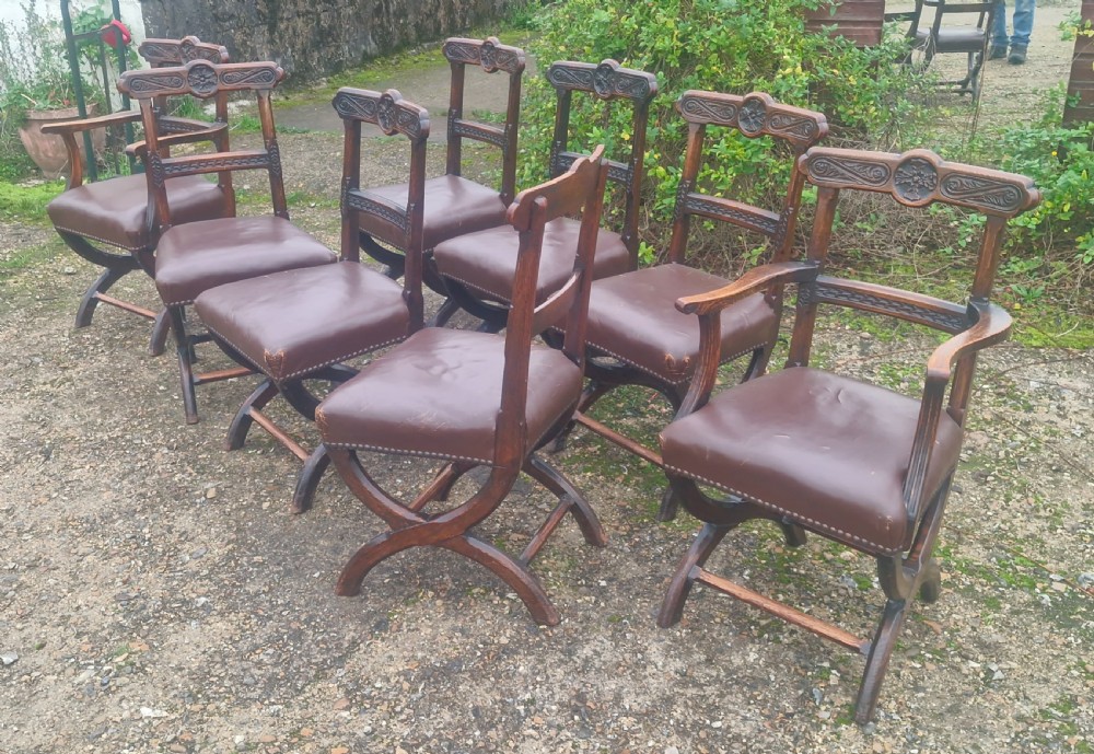 Set of 8 Victorian carved oak Gothic X frame dining chairs . View VII
