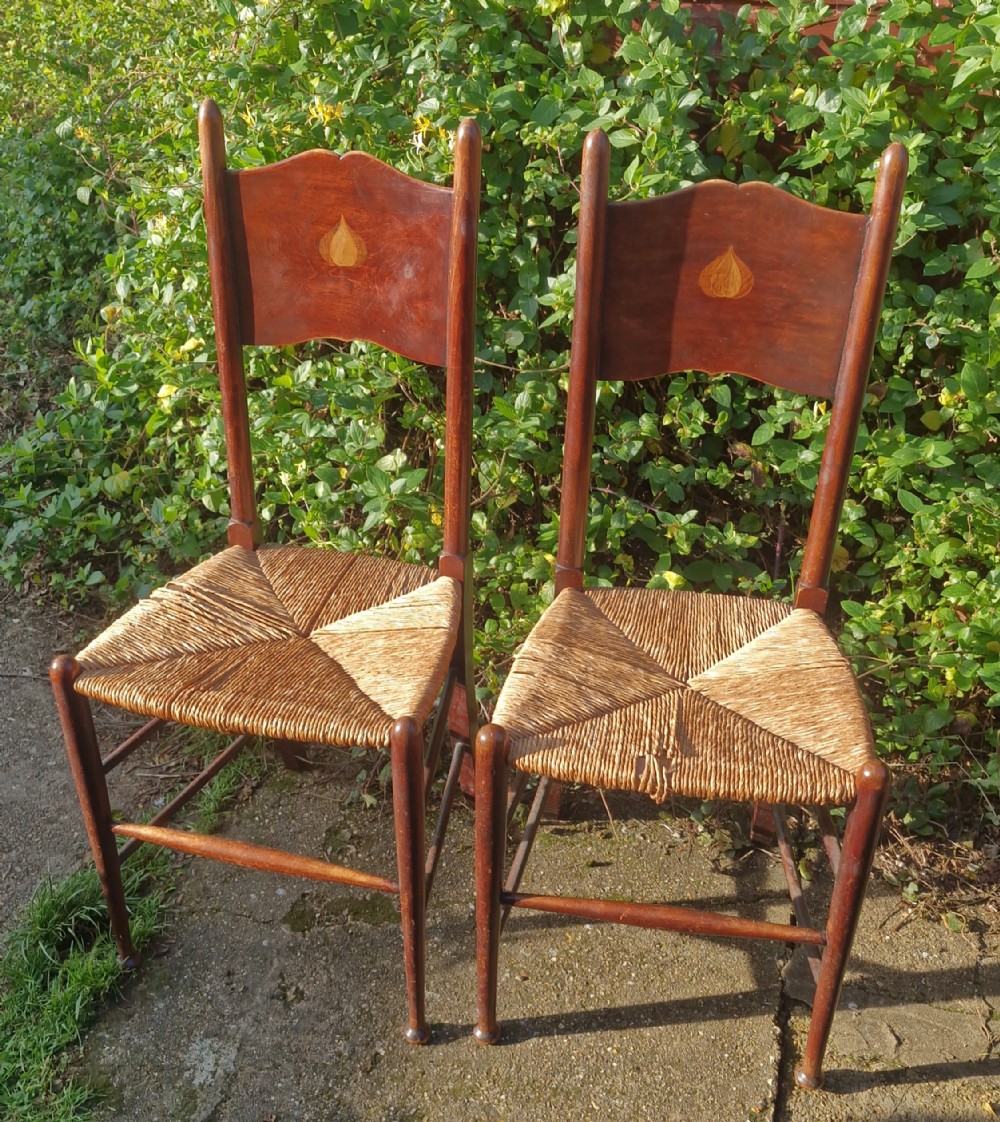 Pair of single chairs in the manner of William Birch. 