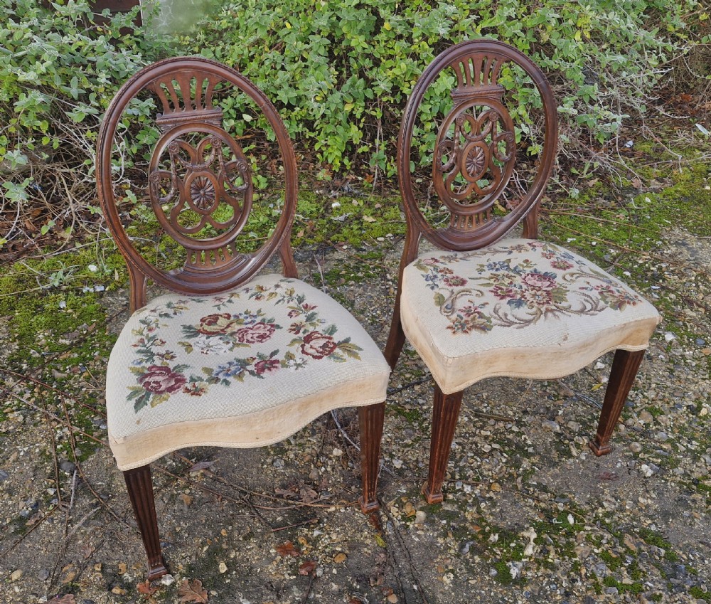 A pair of early 19th-century mahogany side chairs featuring carved oval splats and floral needlepoint upholstered seats. View III
