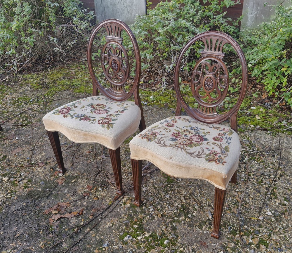 A pair of early 19th-century mahogany side chairs featuring carved oval splats and floral needlepoint upholstered seats. View IV