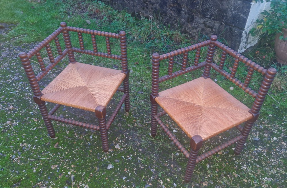 Pair of early 20th century oak bobbin framed corner chairs.