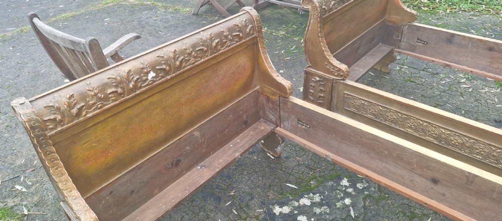 A pair of carved giltwood single sleigh beds featuring scrolled headboards, low scrolled footboards, and carved decorative friezes. View XV