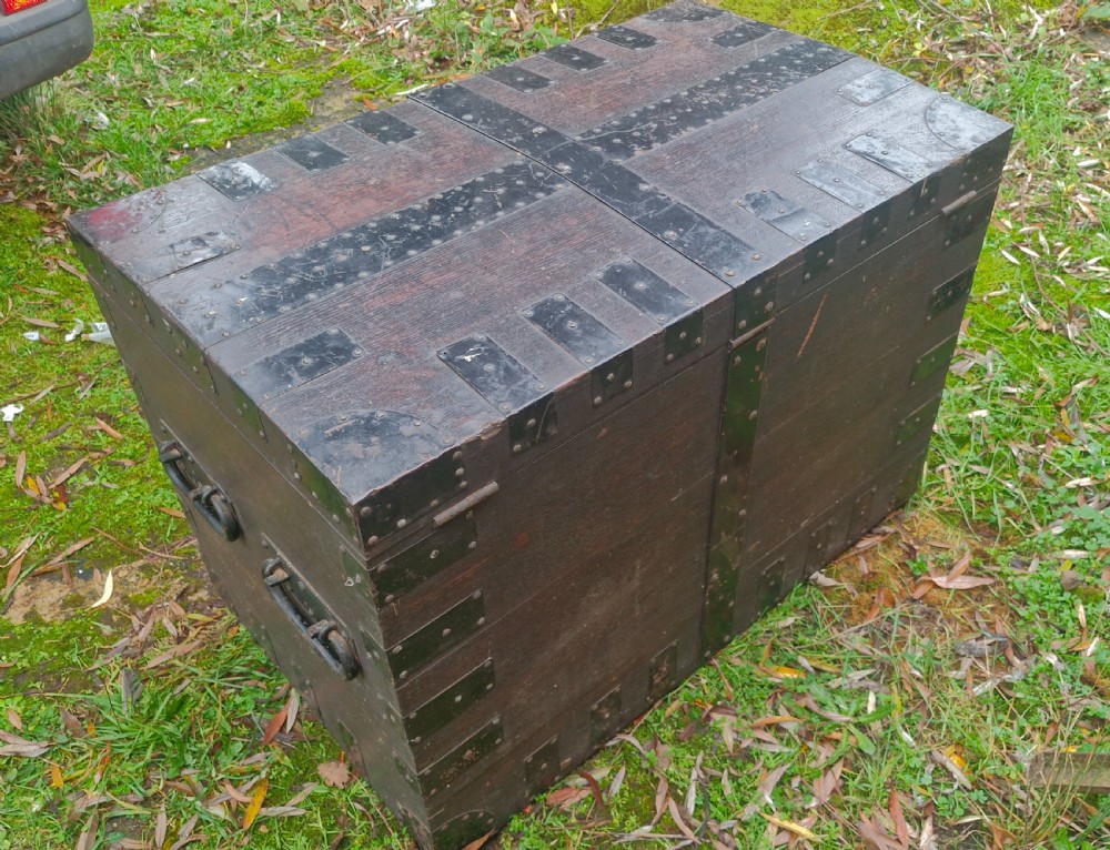 A mid-19th century dark oak silver chest featuring heavy iron corner straps, metal banding, split lid design, and side handles. View II