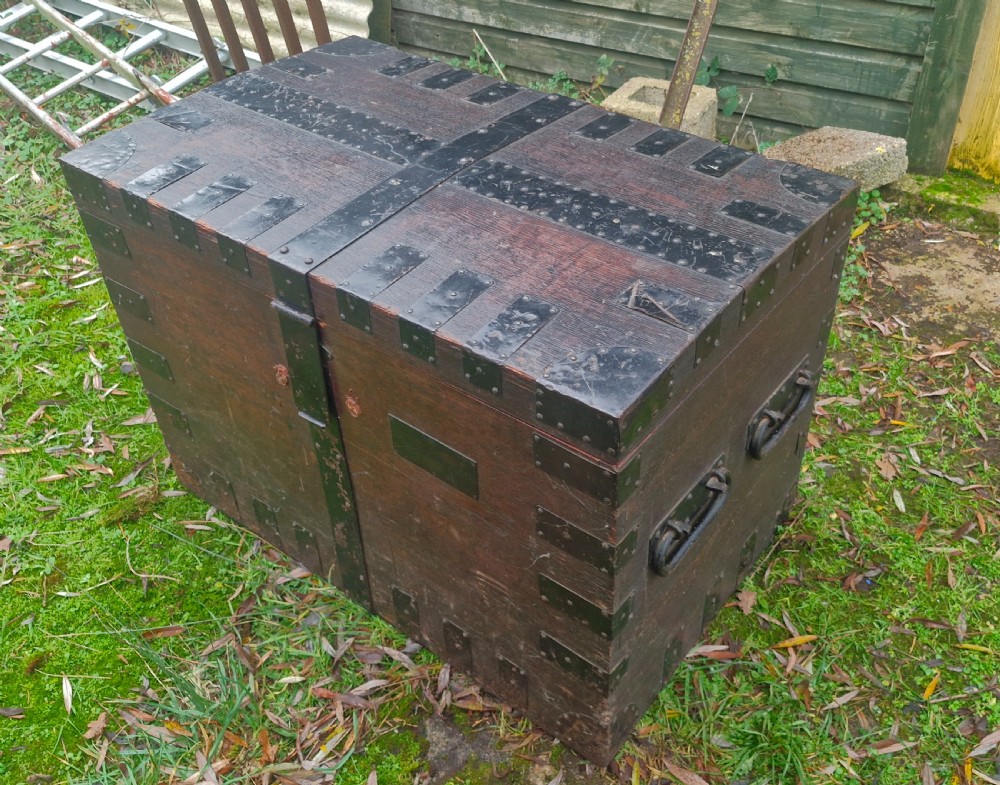 A mid-19th century dark oak silver chest featuring heavy iron corner straps, metal banding, split lid design, and side handles. View VIII