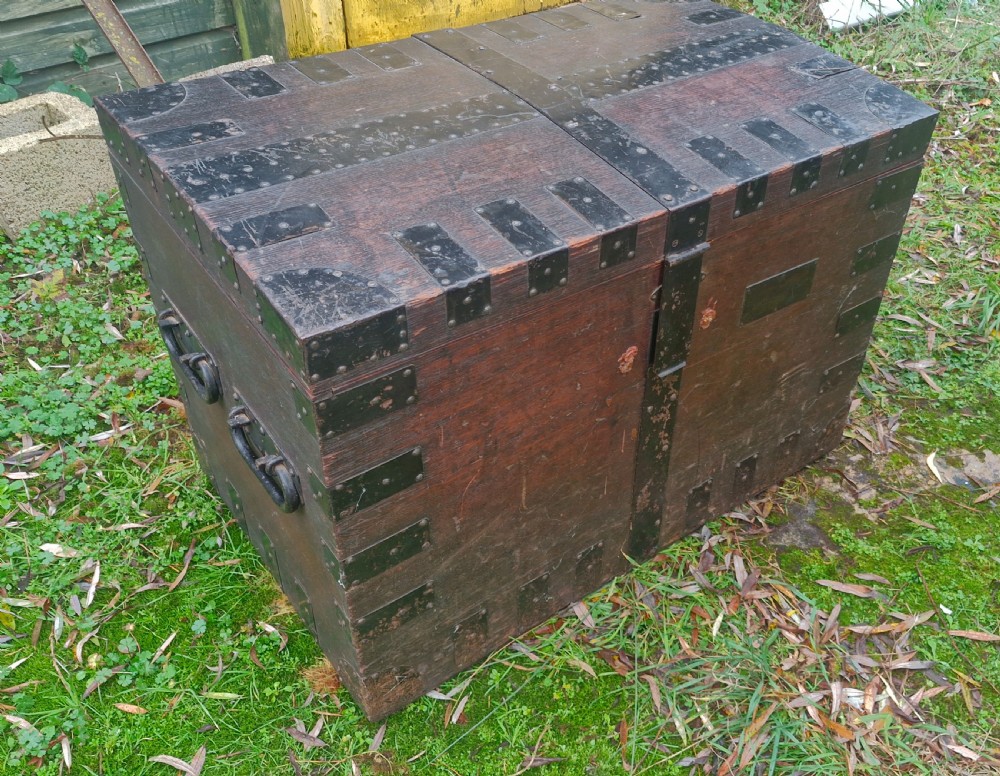 A mid-19th century dark oak silver chest featuring heavy iron corner straps, metal banding, split lid design, and side handles. View IX