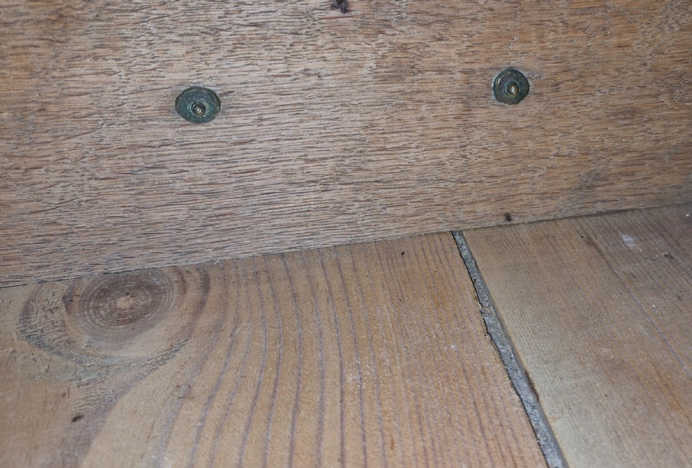 A Georgian oak chest of drawers featuring two short drawers over four long graduating drawers with brass swan-neck handles and bracket feet. View V