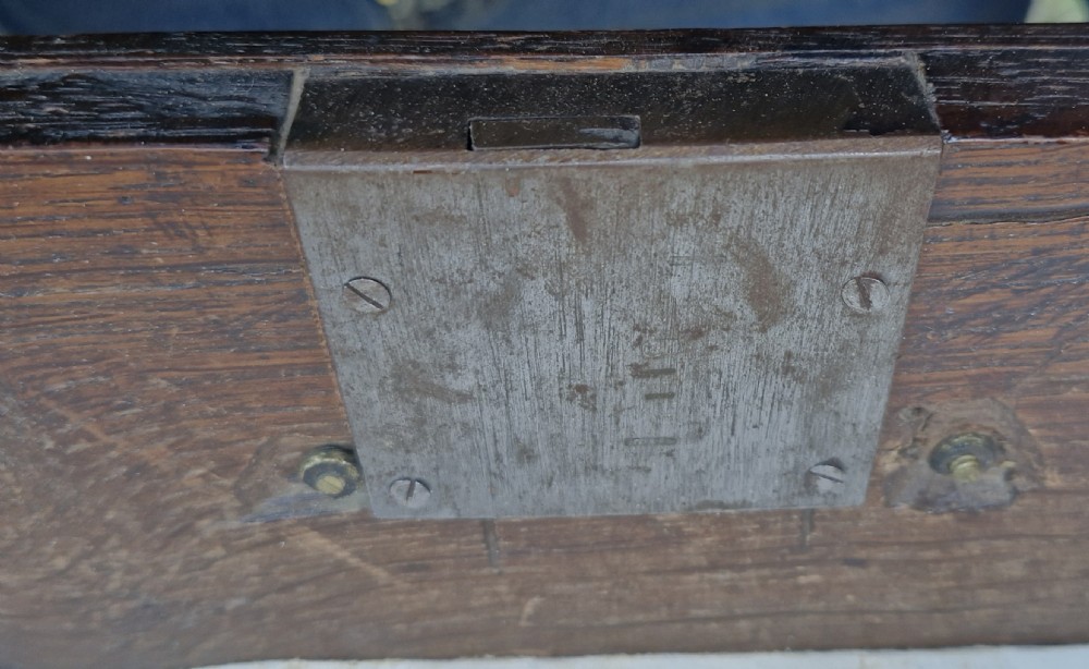 An 18th-century dark oak chest of drawers featuring geometric octagonal panel mouldings, brass drop handles, keyhole escutcheons, and turned bun feet. View III