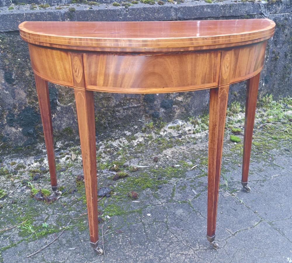 Early 19th century inlaid mahogany demi lune games table. 