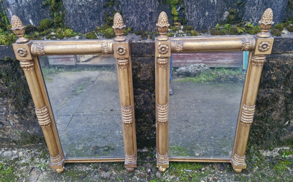Pair of Regency gilded pier mirrors with pineapple finials.