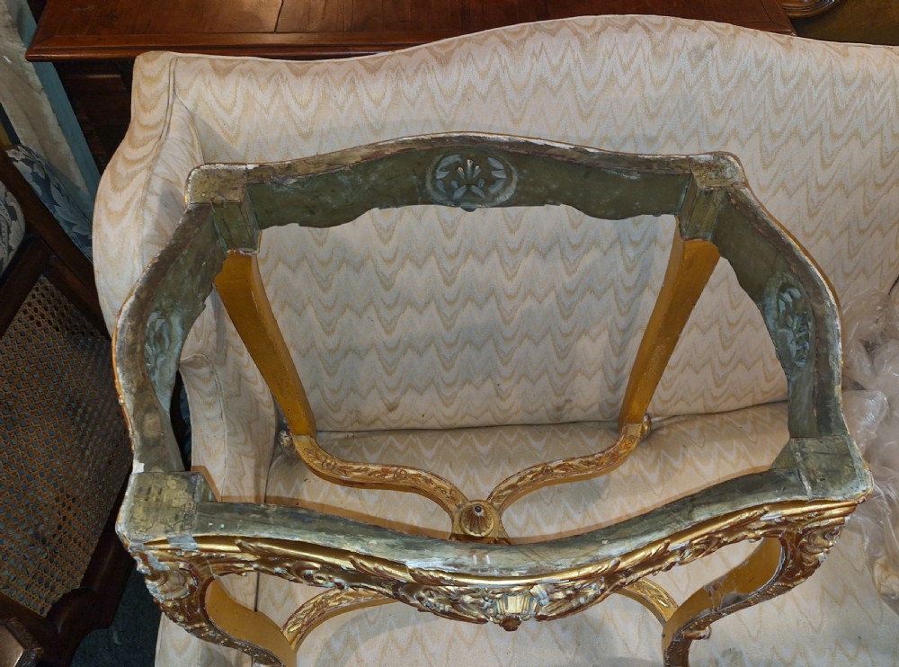 A carved giltwood occasional table featuring cabriole legs, ornate scroll carving, and a shaped veined green marble top. View VI