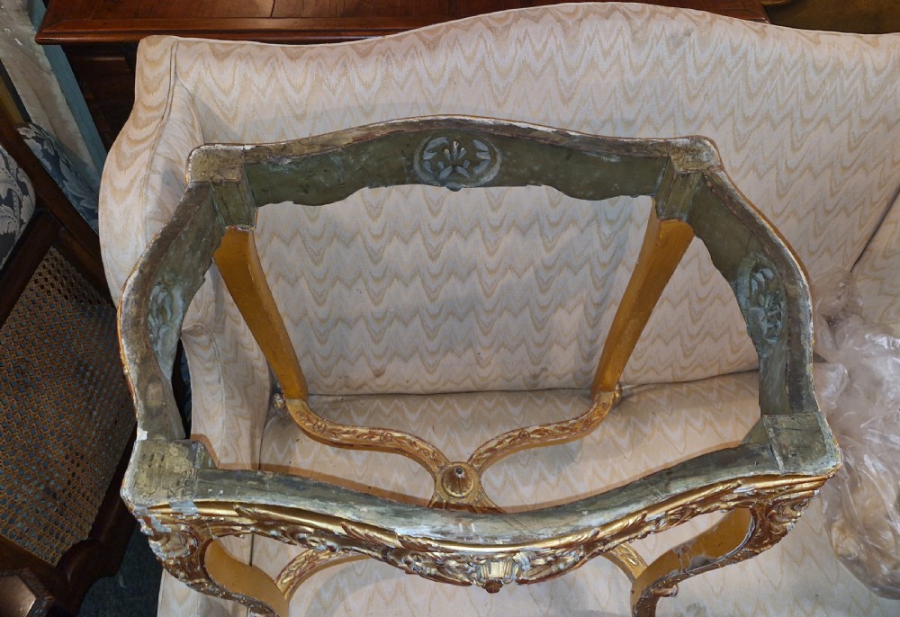 A carved giltwood occasional table featuring cabriole legs, ornate scroll carving, and a shaped veined green marble top. View VII