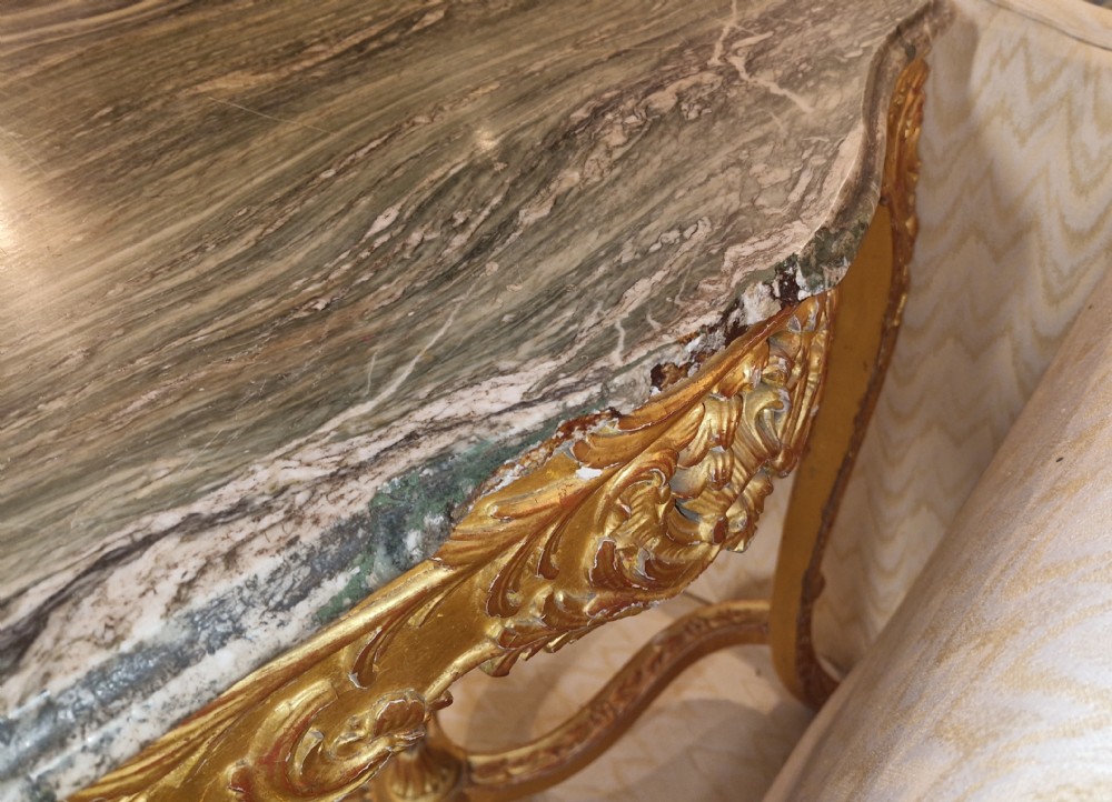 A carved giltwood occasional table featuring cabriole legs, ornate scroll carving, and a shaped veined green marble top. View XIII