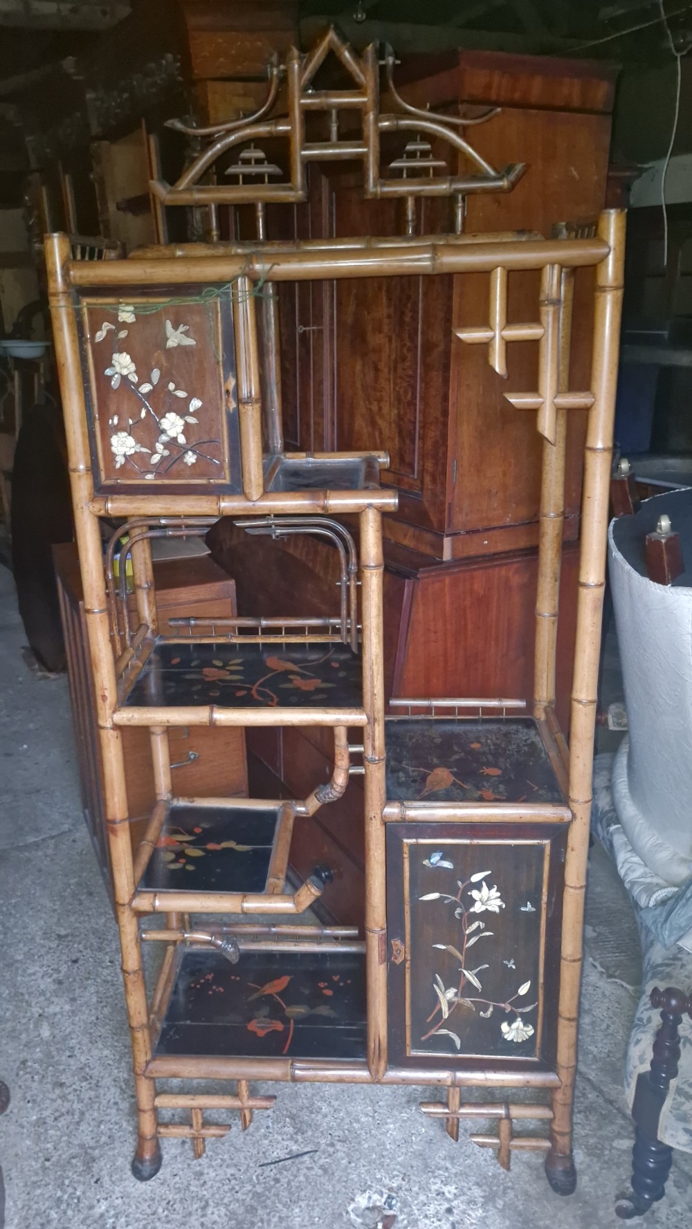 Victorian bamboo and lacquered etagere with bone and mother of pearl inlay.