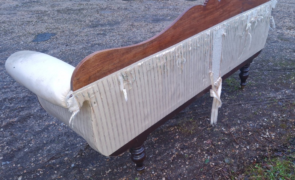 A Regency mahogany scroll-end sofa upholstered in cream striped fabric with matching bolster cushions and turned legs. View VIII