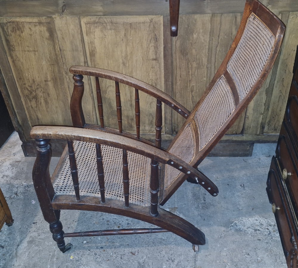 Oak framed armchair in the style of a Phillip Webb design for Morris & Co.