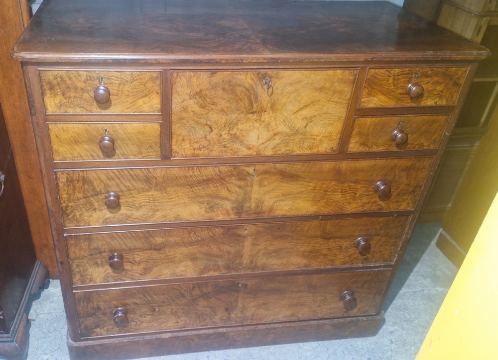 Victorian burr walnut chest of drawers featuring turned timber knobs, multiple small top drawers, and graduating wide drawers. View VIII