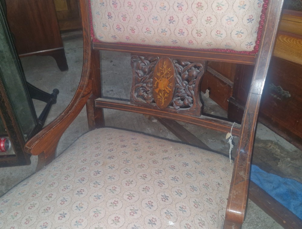 An Edwardian inlaid rosewood bedroom chair with patterned fabric upholstery on the seat and backrest, an inlaid back splat, and turned front legs on castors. View IV