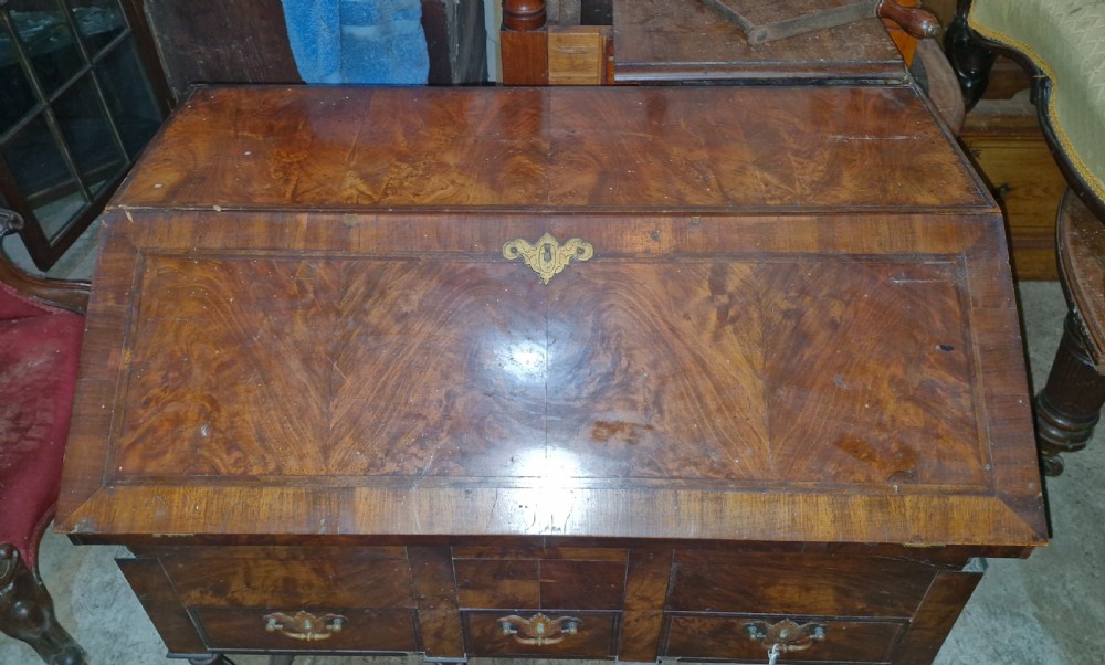 A William and Mary style walnut bureau featuring a slanted fall-front writing flap over three lower drawers, supported on turned legs with cross stretchers. View VI