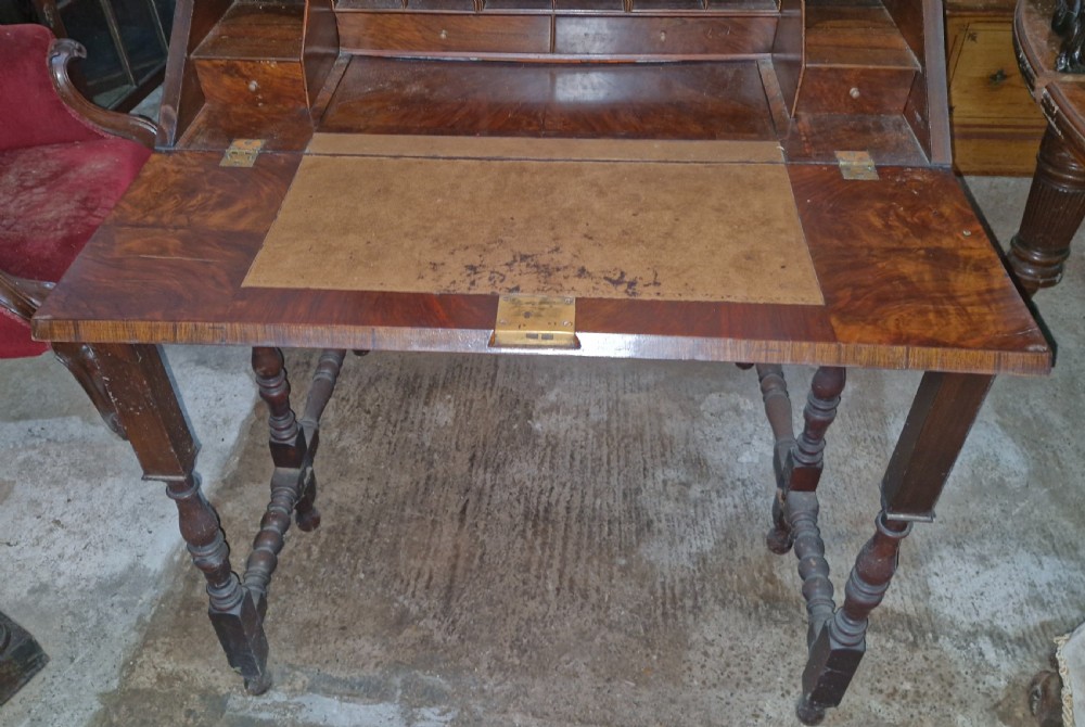 A William and Mary style walnut bureau featuring a slanted fall-front writing flap over three lower drawers, supported on turned legs with cross stretchers. View VIII