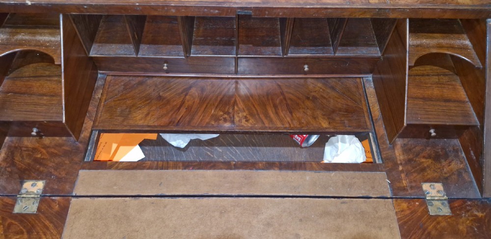 A William and Mary style walnut bureau featuring a slanted fall-front writing flap over three lower drawers, supported on turned legs with cross stretchers. View XI