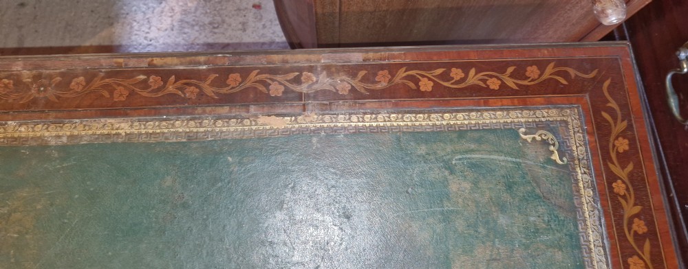 A late Victorian inlaid mahogany kneehole writing desk featuring a green leather insert, multiple drawers with brass handles, and detailed floral marquetry. View XV