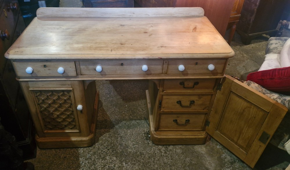 Victorian pine kneehole pedestal writing desk, fitted drawers. 