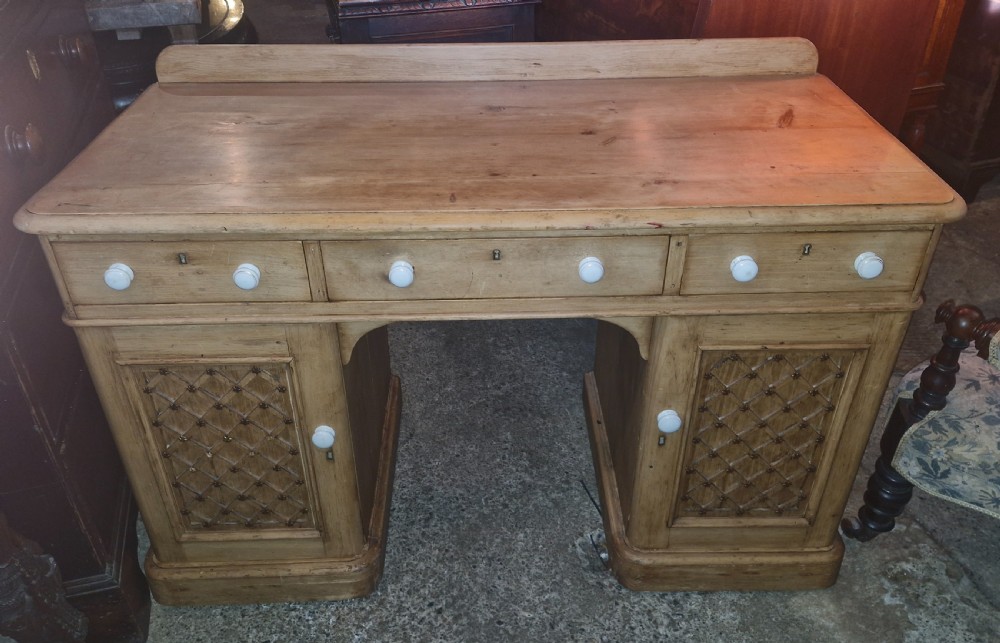 Victorian pine kneehole pedestal writing desk, fitted drawers.  View II