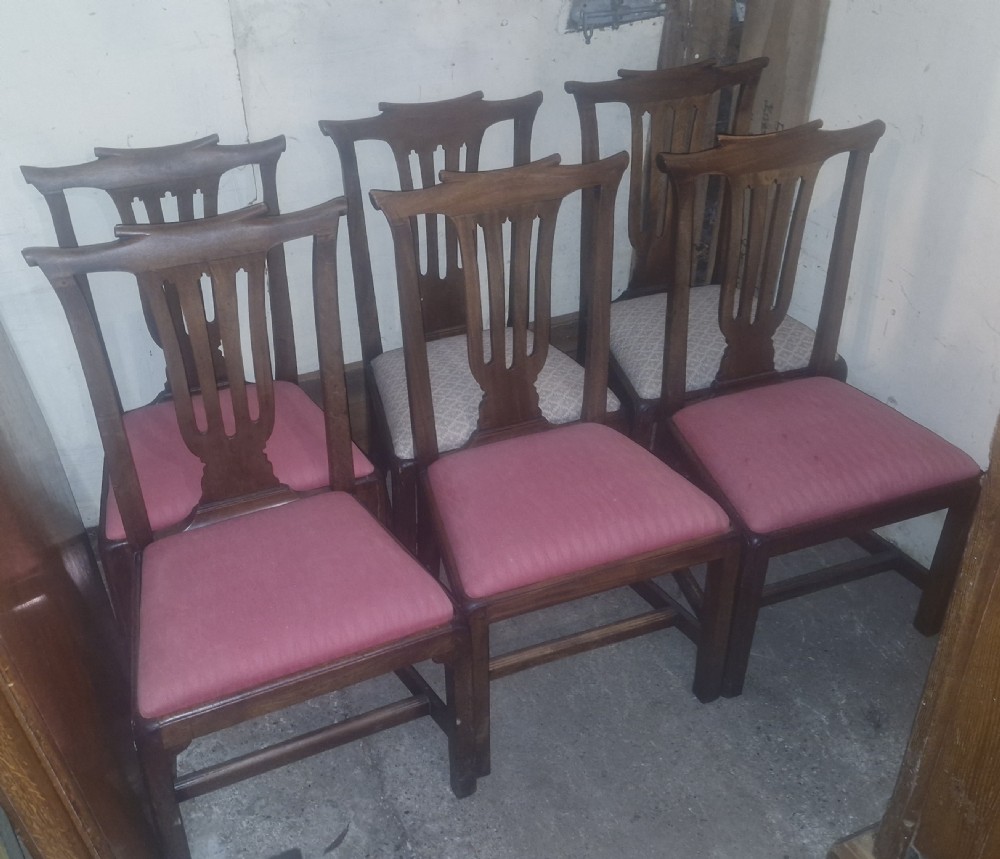 A set of six 18th-century style mahogany dining chairs featuring vertical pierced splats, rectangular backs, and upholstered drop-in seats. View II