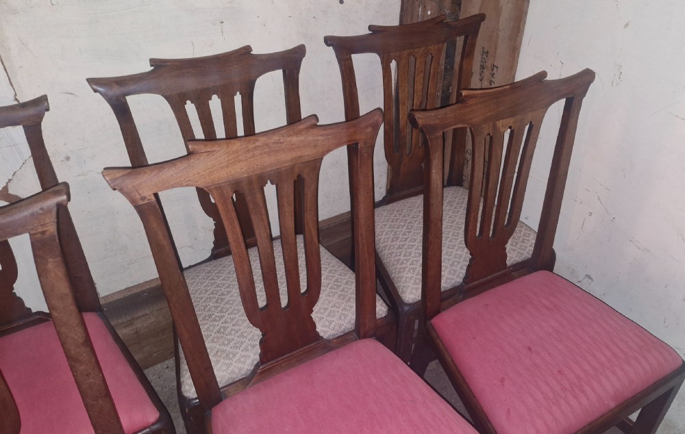A set of six 18th-century style mahogany dining chairs featuring vertical pierced splats, rectangular backs, and upholstered drop-in seats. View VIII