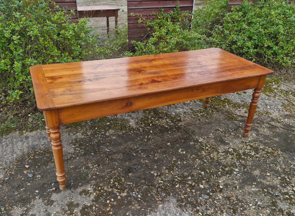 A long rectangular wooden French farmhouse dining table featuring turned legs, an open side drawer, and an extended pull-out bread slide. View III