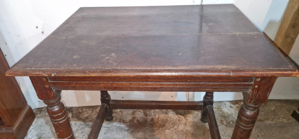 An 18th-century dark oak side table featuring a rectangular plank top, turned legs, and lower wooden stretchers. View III
