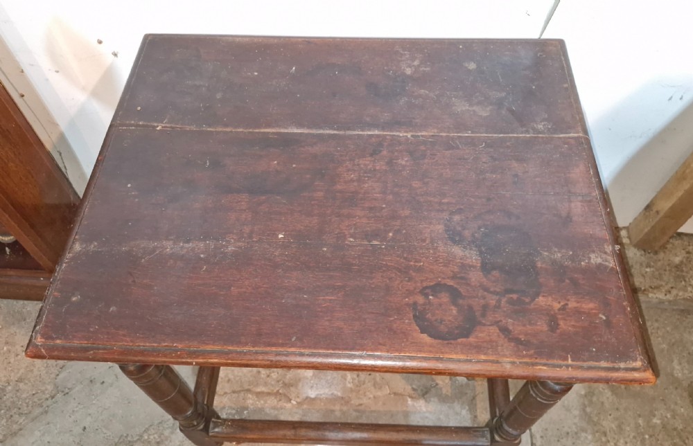 An 18th-century dark oak side table featuring a rectangular plank top, turned legs, and lower wooden stretchers. View VI