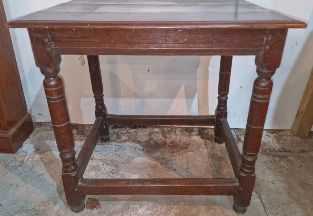 An 18th-century dark oak side table featuring a rectangular plank top, turned legs, and lower wooden stretchers. View VIII