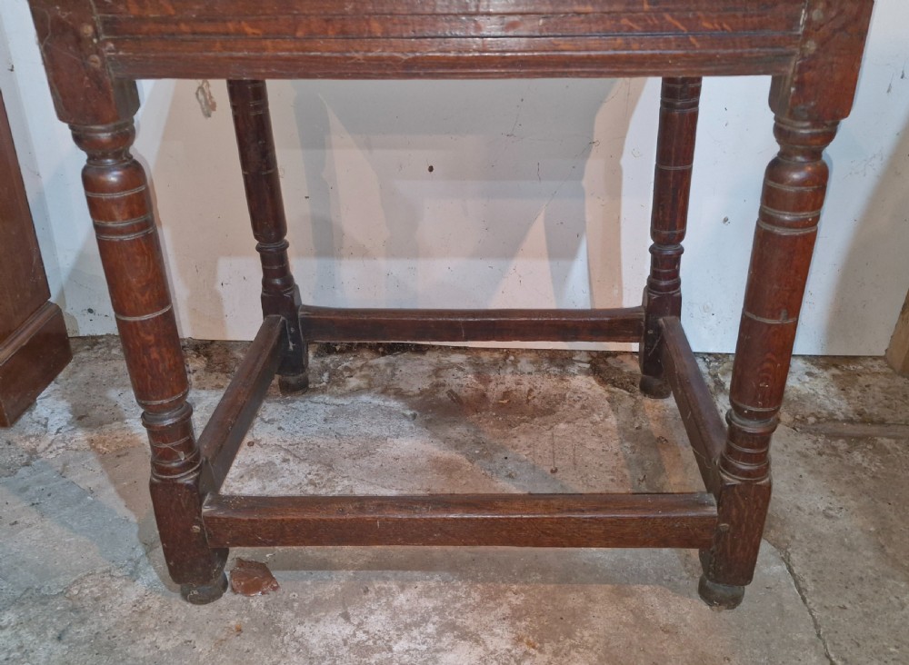 An 18th-century dark oak side table featuring a rectangular plank top, turned legs, and lower wooden stretchers. View IX