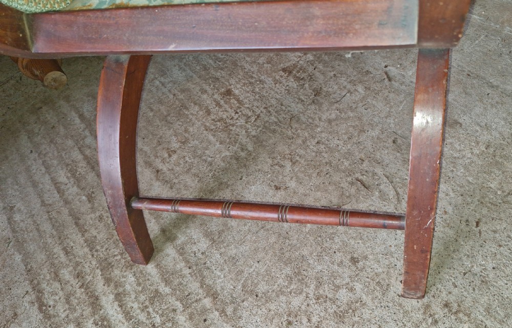 An Edwardian inlaid mahogany X-frame armchair featuring curved legs, inlaid wood details, and light blue fabric upholstery on the seat, backrest, and armrests. View V
