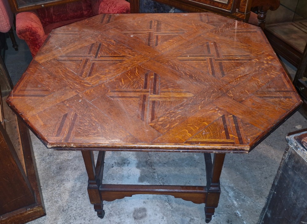 An octagonal late Victorian hall table featuring a geometric inlaid parquetry wood top supported by turned legs and cross stretchers. View II