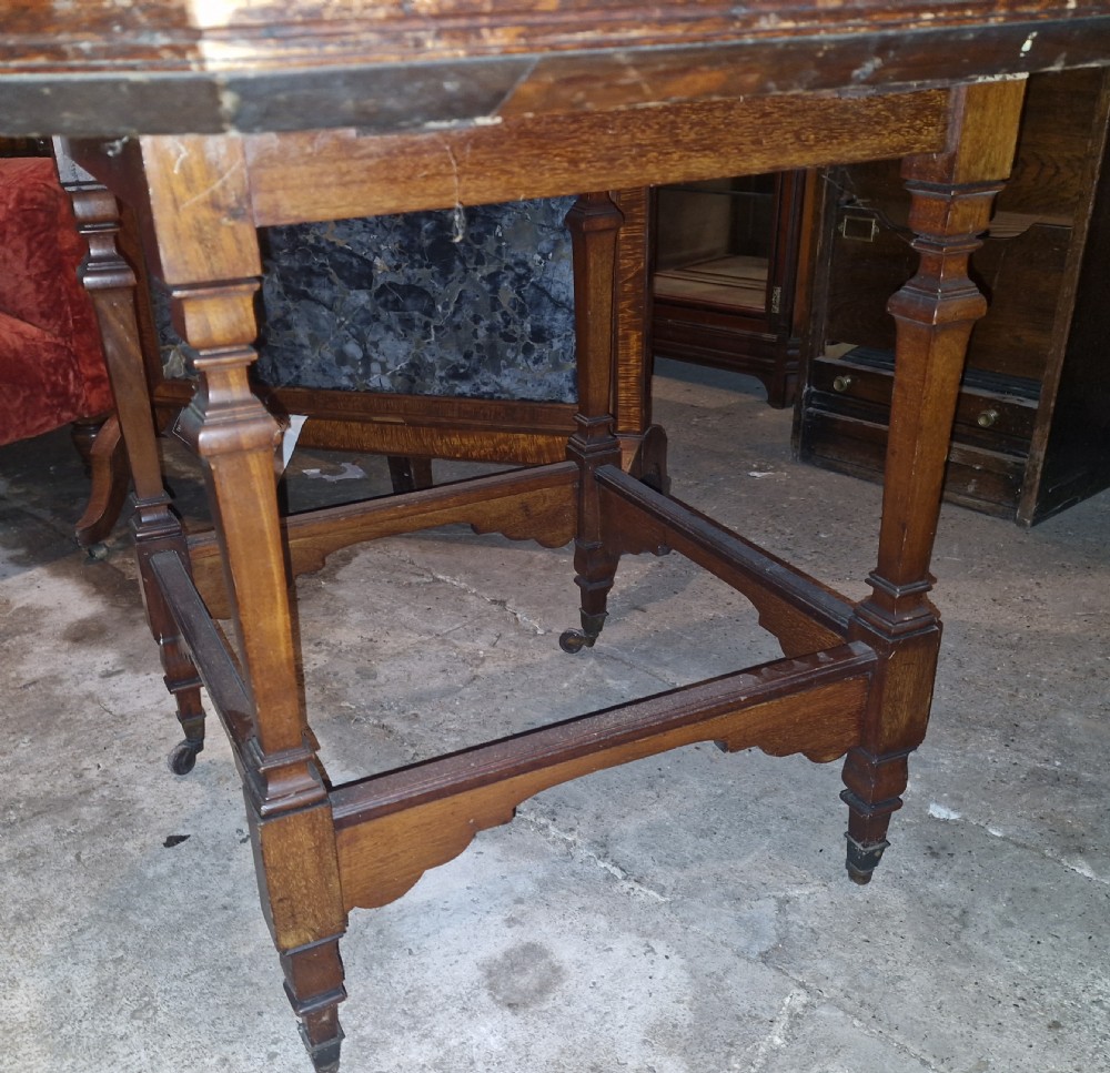 An octagonal late Victorian hall table featuring a geometric inlaid parquetry wood top supported by turned legs and cross stretchers. View VI