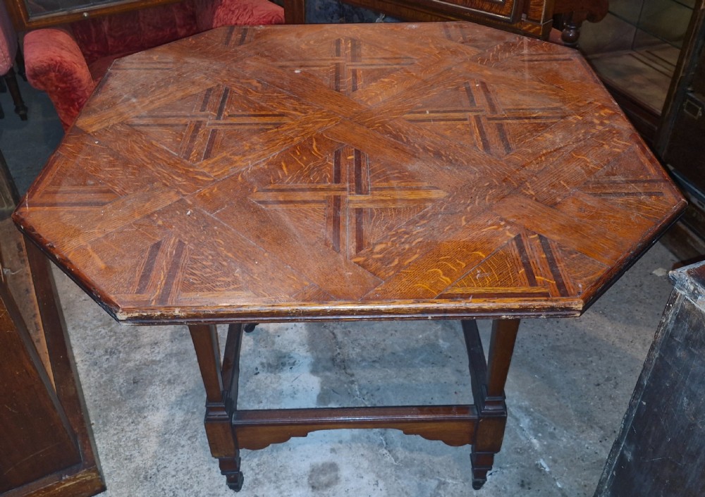 An octagonal late Victorian hall table featuring a geometric inlaid parquetry wood top supported by turned legs and cross stretchers. View VII