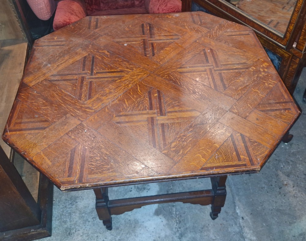 An octagonal late Victorian hall table featuring a geometric inlaid parquetry wood top supported by turned legs and cross stretchers. View VIII