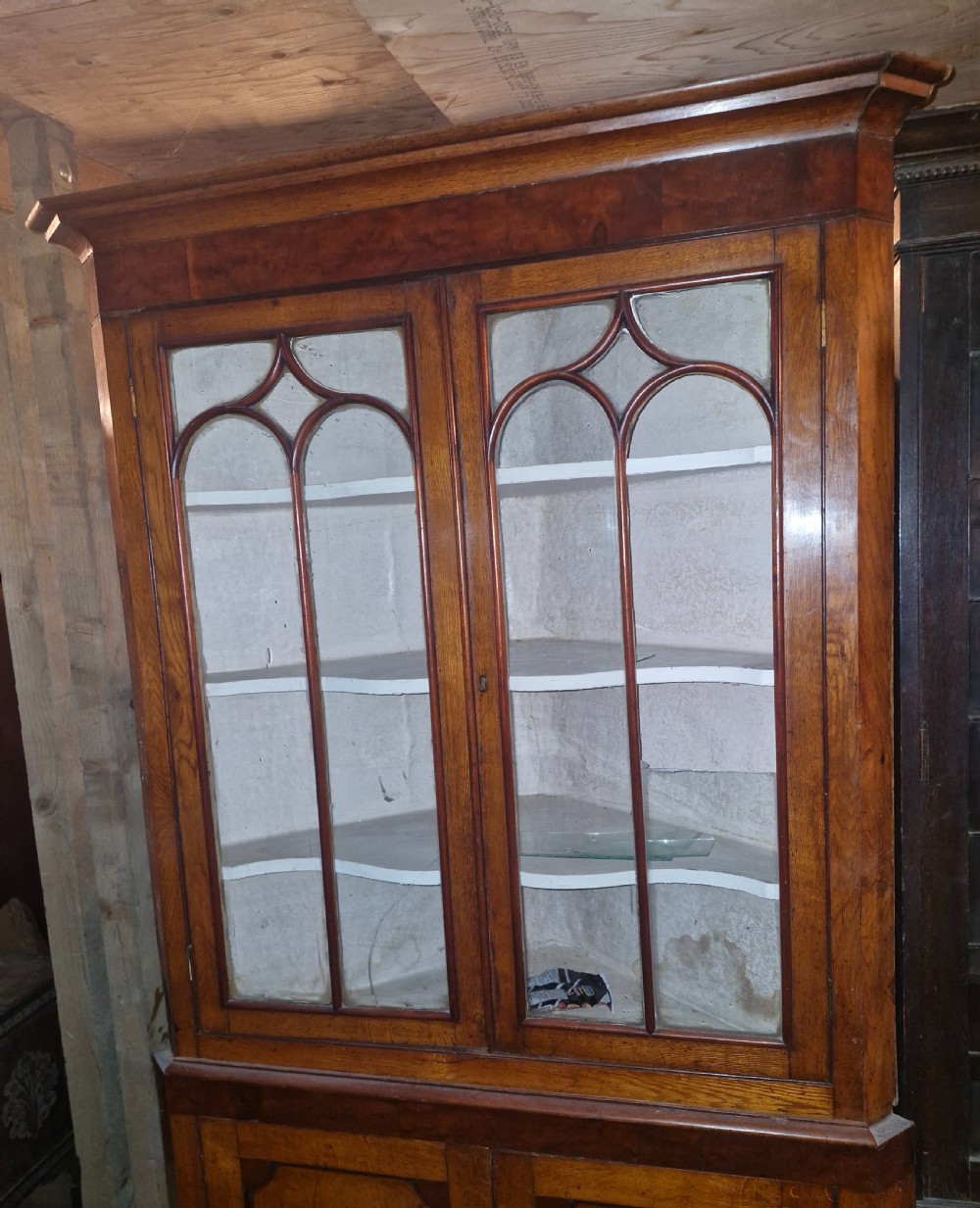 An early Victorian floor-standing Welsh corner cupboard crafted in oak and mahogany, featuring astragal glazed upper doors and solid panelled lower doors. View VI